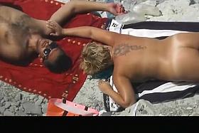 Chubby tattooed nudist woman sunbathing