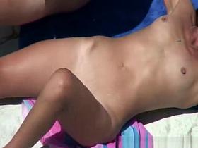 Redhead nudist sunbating her body