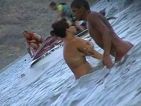 Nude beach voyeur scenes with amateurs bathing in the sea