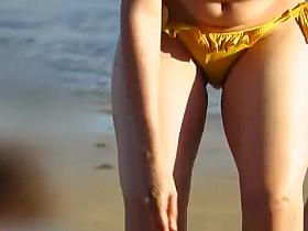 Hot girl in yellow bikini at the beach