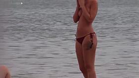 Slim babe with sexy body filmed with her tits out on the beach