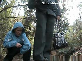Chubby old woman caught pissing in the bushes