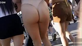 Big booty chick walks the street in a thong