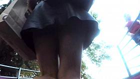 Upskirt in the stairs of aleather skirt