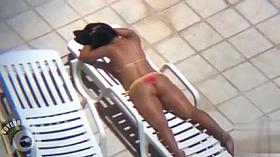 Long zoom on her tanned pair of buttocks