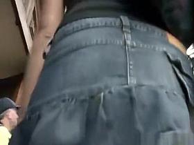 Brunette girl in short jeans skirt upskirt
