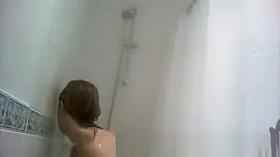 Blonde woman taking warm shower