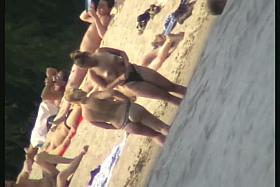 Mature women with big butts taking sunbaths on the beach
