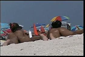 Amazing beach voyeur vid of two nudist girls and their wet pussies
