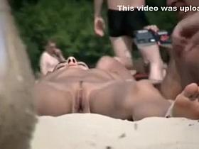 Sexy brunette lies naked in the sand