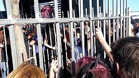 Blonde in the cage is performing erotic strip show in public