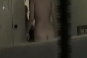 Girl is naked exposing hot firm boobs on window voyeur cam