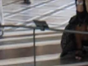 Upskirt girl sitting on hunkers and getting spied in Louvre