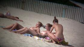 Porno of thin nude chicks on a nudist beach relaxing and talking
