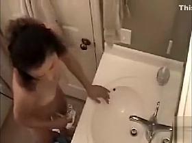 Cute young brunette masturbates in bathroom