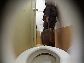 Woman takes a leak in toilet