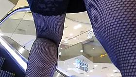 Fishnet stockings upskirt on escalator 2