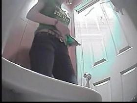 A girl takes off her jeans and pees in front of a toilet voyeur camera