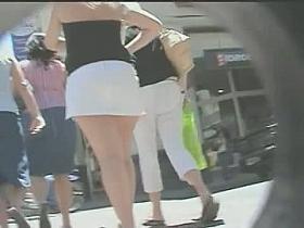 Public spy cam video of a woman's ass cheeks peeking out of her short skirt