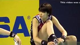 Asian volleyball girls stretch before a match