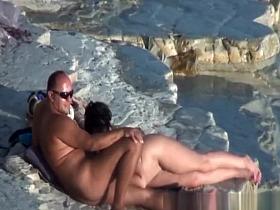 Nude couple fucking at rocky beach