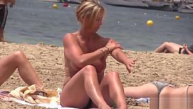Hot MILF with huge tits on topless beach
