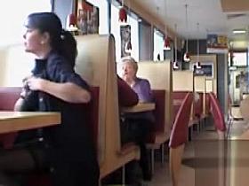 Brunette MILF flashing her jugs in a restaurant