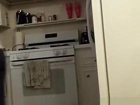 Girlfriend in leggings cleaning the kitchen