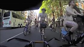 Group of nudists cycle through a town in their birthday suits