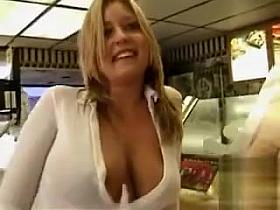 Scantily clad babe flashes her boobies in public