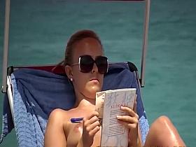 Spying a topless girl reading on a beach