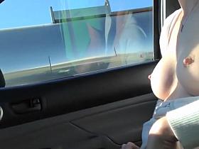 Kinky girl shows off in a moving car
