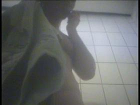 This changing room spy cam video shows a girl wiping herself with a towel