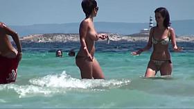 Topless brunette friends with nice tits on the beach