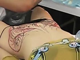 Blonde bimbo moans with pain as her pubis was being tattooed